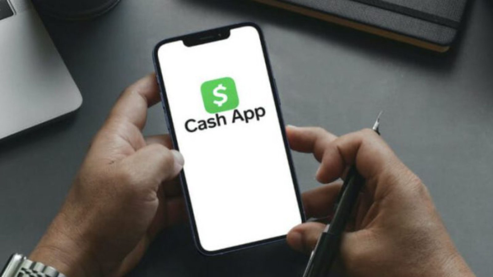 A Picture of a Man Holding a Phone with a Cash App Apllication on the Screen 